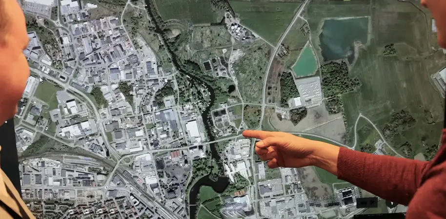 persons pointing at map